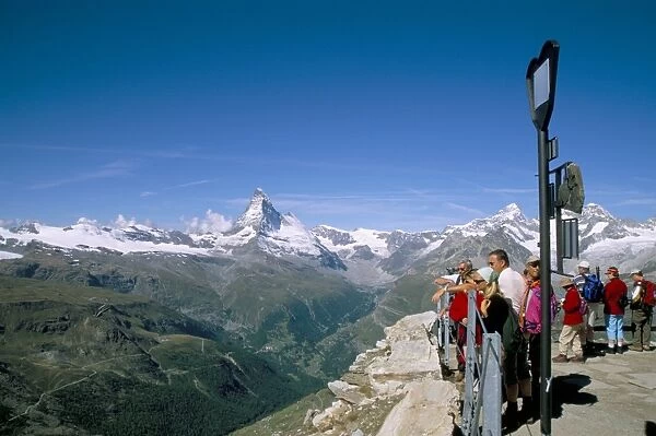 Tourists looking at view from Rothorn to Matterhorn