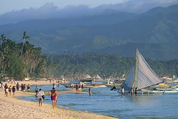Tourists and outrigger canoes on White Sun Beach