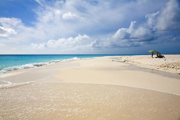 Tourists relax on beach under sun umbrellas, Cayo de Agua, Archipelago Los Roques National Park