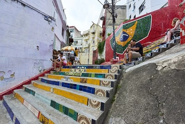 Tourists sitting on Selaron Steps, 215 decorated steps the work of artist Jorge Selaron