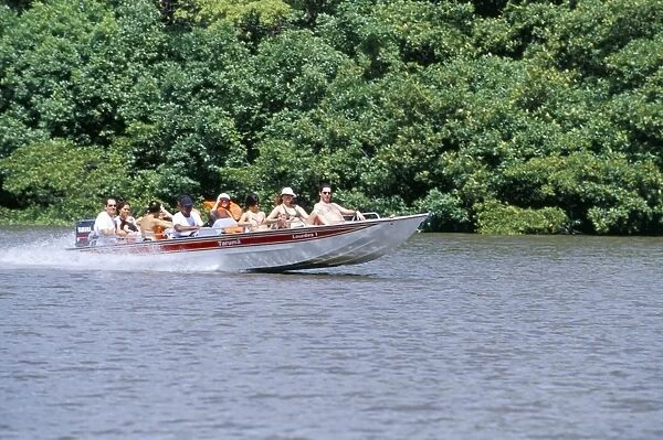 Tourists in speed boat riding on Rio Preguica, Parque Nacional dos Lencois Maranhenses