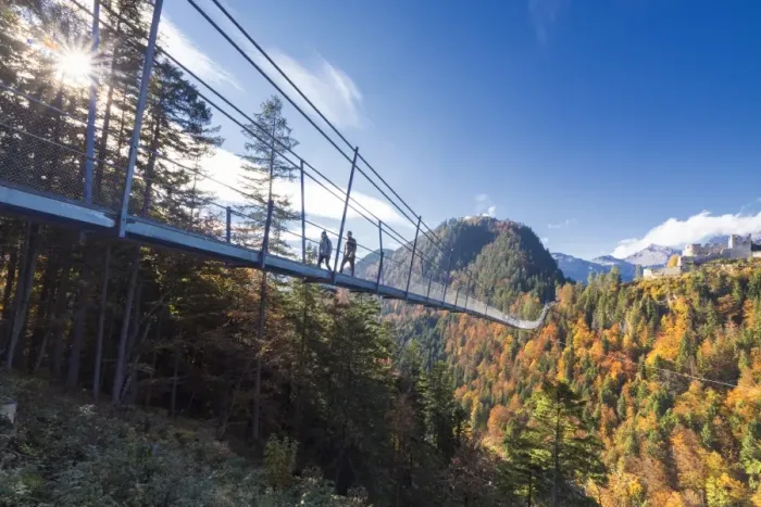 Framed Print : Tourists on the suspension bridge called Highline 179 framed by colorful woods in autumn Framed Print : Tourists on the suspension bridge called Highline 179 framed by colorful woods in autumn