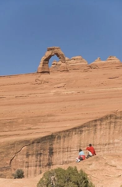 Tourists viewing the Delicate Arch, Arches National Park, Utah, United States of America