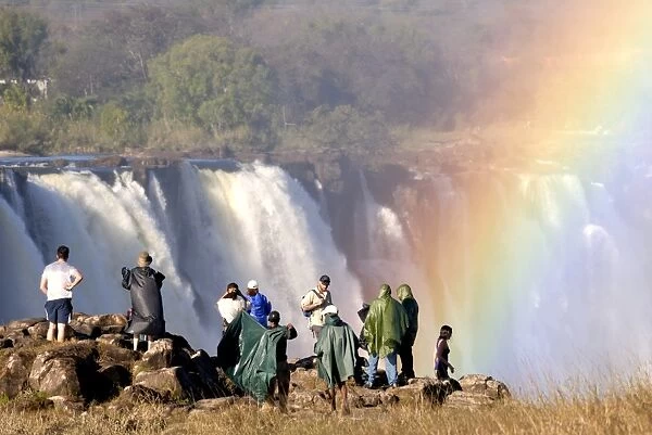 Tourists viewing Victoria Falls, UNESCO World Heritage Site, Zimbabwe, Africa