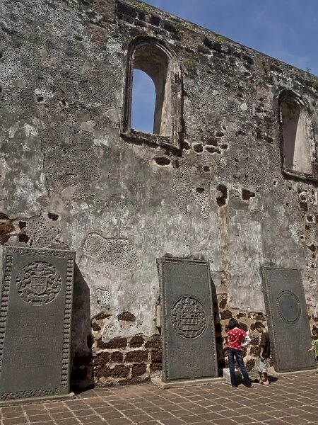 Tourists visit St. Pauls Hill with ruins of historical Portuguese fortress in Melaka (Malacca)