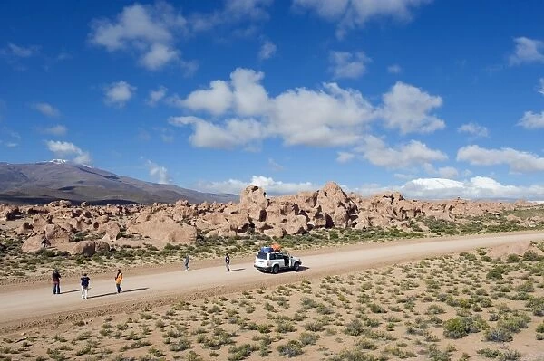 Tourists visiting rock formations in the altiplano desert, Bolivia, South America