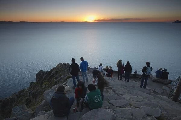Tourists watching sunset from summit of Cerro Calvario, Copacabana, Lake Titicaca, Bolivia, South America