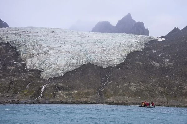 Tourists on a zodiac watching a glacier on Elephant Island, South Shetland Islands