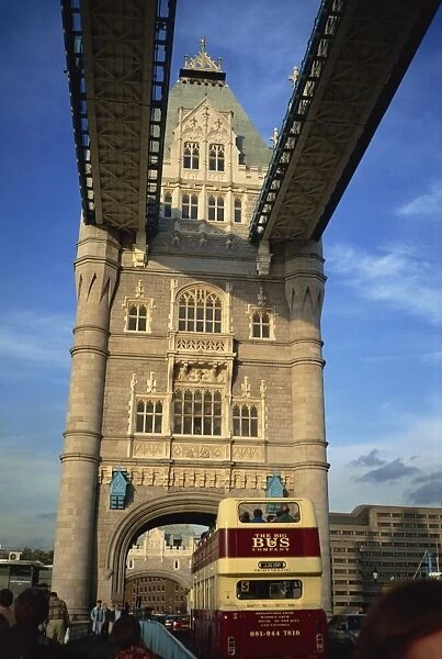 Detail of Tower Bridge, with double-decker bus passing through, London
