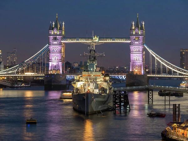 Tower Bridge and HMS Belfast on the River Thames at dusk, London, England, United Kingdom