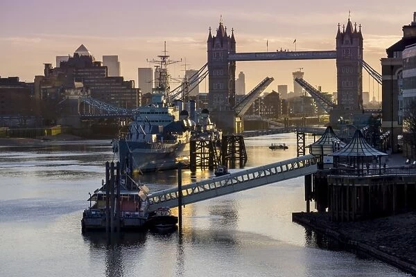 Tower Bridge raising deck with HMS Belfast on the River Thames, London, England, United Kingdom