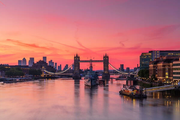 Tower Bridge, River Thames and HMS Belfast at sunrise with pink sky