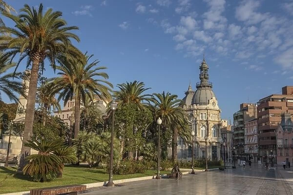 Town Hall under a cloud dappled blue sky with palm trees and roses, Cartagena, Murcia Region