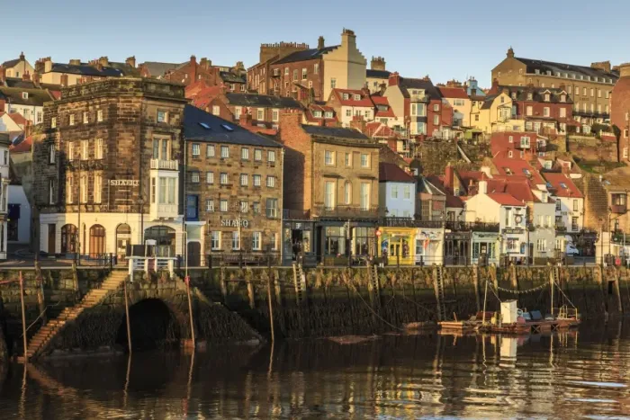 Framed Print : Townhouses, bars and restaurants on Pier Road, West Side of River Esk, lit by low sun in winter Framed Print : Townhouses, bars and restaurants on Pier Road, West Side of River Esk, lit by low sun in winter