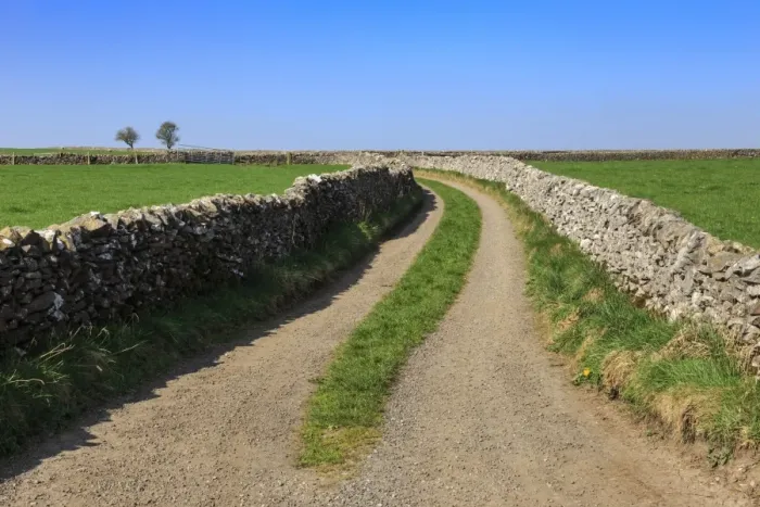 Framed Print : Track disappears into distance, between dry stone walls, a typical country scene Framed Print : Track disappears into distance, between dry stone walls, a typical country scene