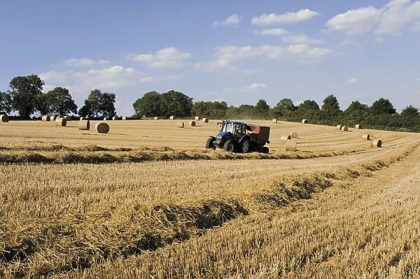 Tractor harvesting near Chipping Campden, along the Cotswolds Way footpath