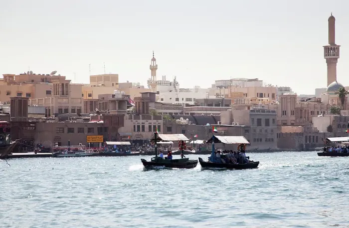 Framed Print : Traditional Abra ferries crossing Dubai Creek which divides the city into two sections of Deira and Bur Dubai, Dubai, United Arab Emirates Framed Print : Traditional Abra ferries crossing Dubai Creek which divides the city into two sections of Deira and Bur Dubai, Dubai, United Arab Emirates