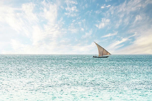 Traditional African dhow sailing in the calm waters of the Indian Ocean, Zanzibar, Tanzania, East Africa, Africa