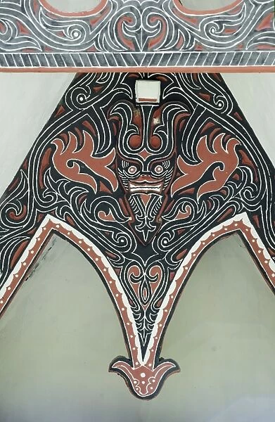 Detail of traditional Batak tribal painted carving with stylised buffalo horns, Huta Bolon, Simanindo, Sumatra, Indonesia, Southeast Asia, Asia