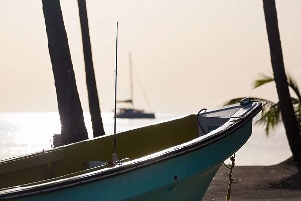 Traditional boat on the beach at Marigot Bay at dusk, St. Lucia, Windward Islands