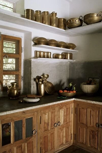 Traditional brass kitchen utensils in kitchen area