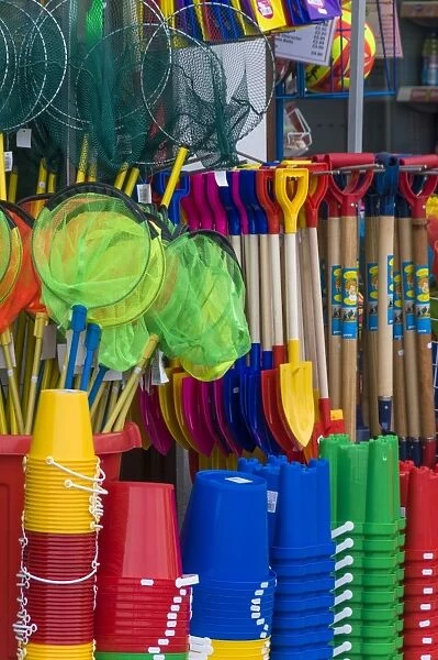 Traditional buckets and spades on sale in a seaside shop in Lyme Regis, Dorset, England, United Kingdom, Europe