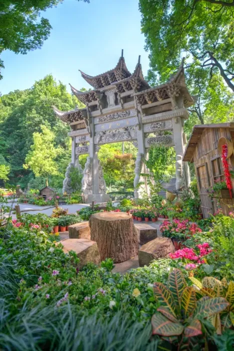Framed Print : Traditional Chinese stone gate, a place to rest amidst lush vegetation and floral Framed Print : Traditional Chinese stone gate, a place to rest amidst lush vegetation and floral