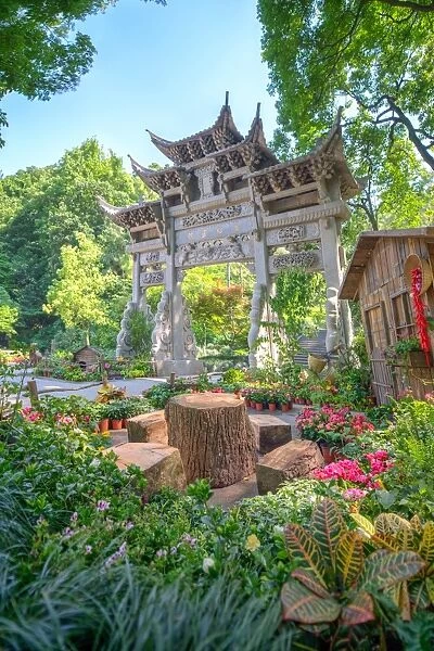 Traditional Chinese stone gate, a place to rest amidst lush vegetation and floral