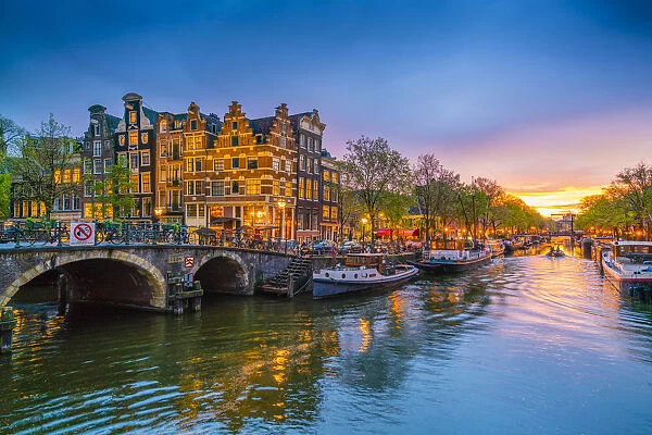 Traditional Dutch gabled houses and canal at dusk, Amsterdam, Netherlands, Europe