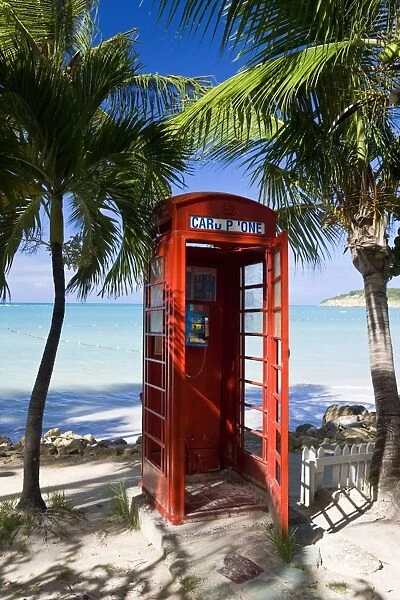 Traditional English red telephone box on the beach at Dickenson Bay, Antigua