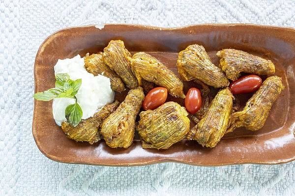 Traditional fried stuffed zucchini flowers with Tzatziki sauce, Crete island, Greek Islands, Greece, Europe