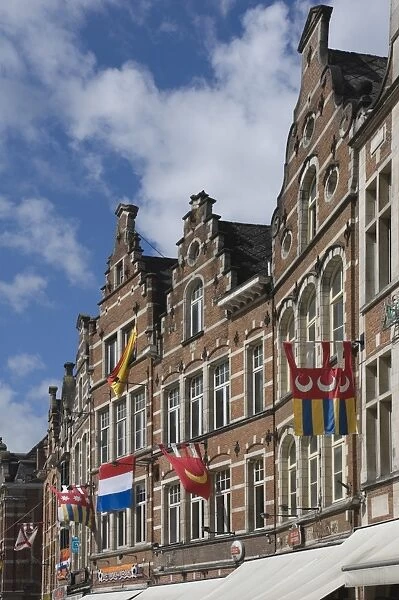 Traditional gabled facades decorated with heraldic banners, Oude Markt, Leuven, Belgium, Europe