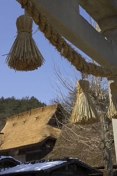 Traditional hay bobbles hanging from Shinto torii with