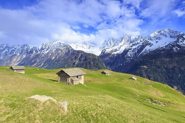 Traditional huts with Pizzo Badile in the background, Soglio, Val Bregaglia (Bregaglia Valley)
