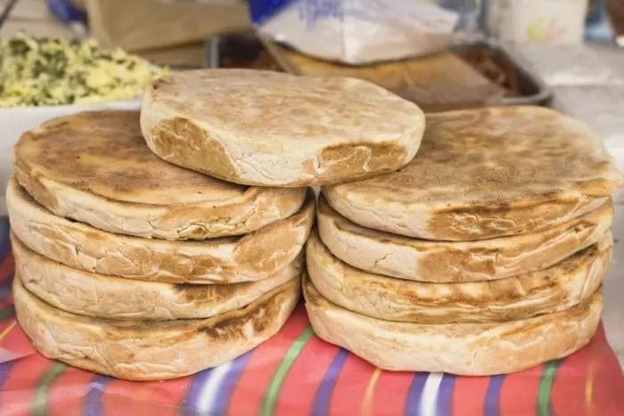 Framed Print : Traditional Madeiran flat bread is cooked and served at a stall in Funchal