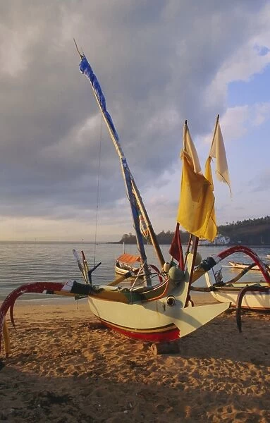 Traditional outrigger boats drawn up on the beach in