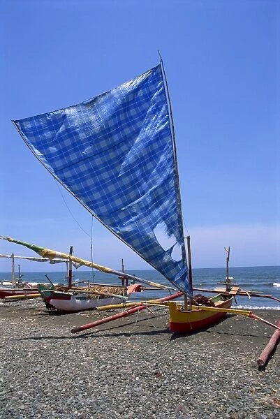 Traditional outrigger boats which fish at night for squid