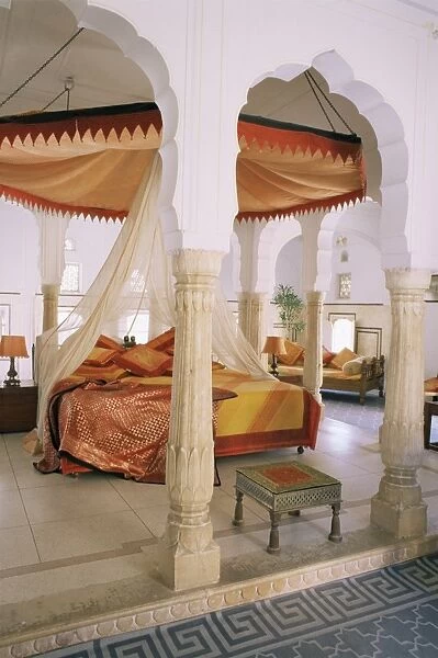 Traditional Rajput columns and cuspid arches in tented guest bedroom