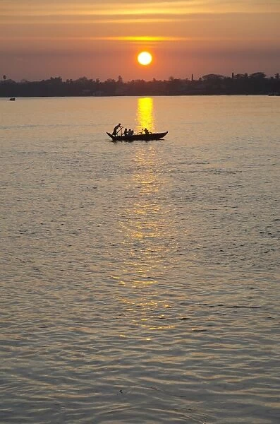 Traditional rowing boat on the river at sunset, Pathein, Irrawaddy Delta, Myamar (Burma), Asia