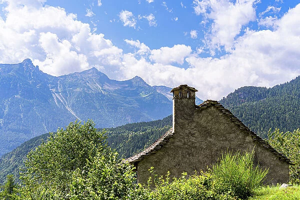 A traditional rural architecture style house built of rocks from the mountain in a beautiful alpine valley in summer, Piemonte (Piedmont), Northern Italy, Europe