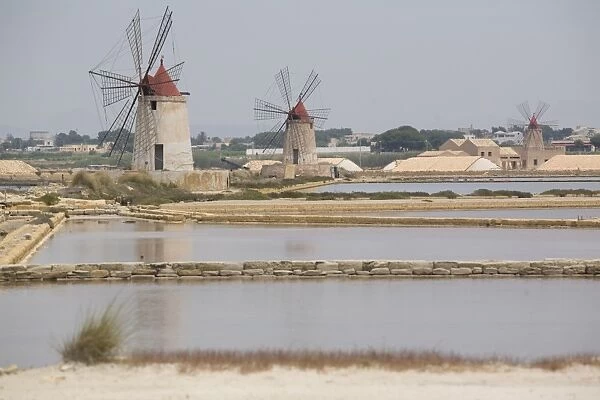 Traditional sea salt beds and windmills, Mozia, Sicily, Italy, Europe