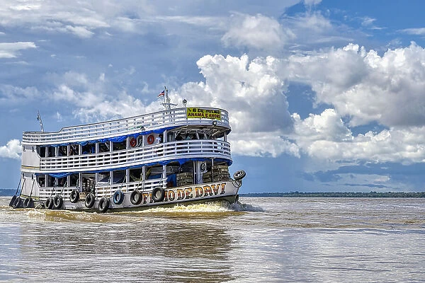 Traditional wooden boat navigating on the Rio Negro, Manaus, Amazonia State, Brazil, South America