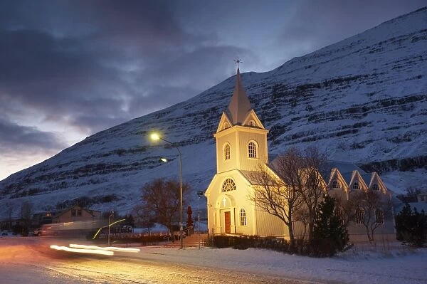 Traditional wooden church at night, built in 1922, at Seydisfjordur, a town founded in 1895 by a Norwegian fishing company, now main ferry port to and from Europe in the East Fjords, Iceland