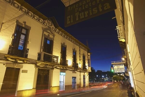 Traffic passing along street at dusk, Sucre, UNESCO World Heritage Site, Bolivia, South America