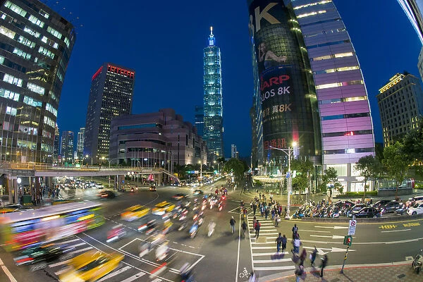 Traffic in front of Taipei 101 at a busy downtown intersection in the Xinyi district