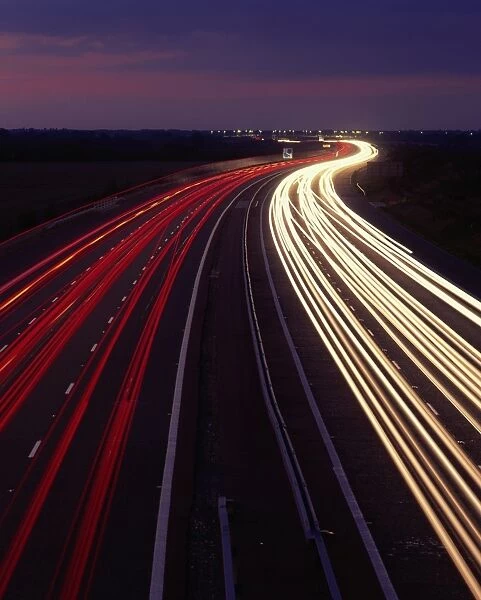 Trails of light on motorway at night, England, United Kingdom, Europe