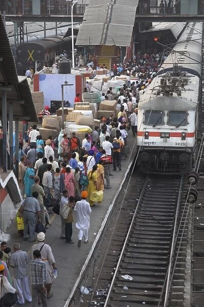Train ariving at crowded platform in New Delhi train station