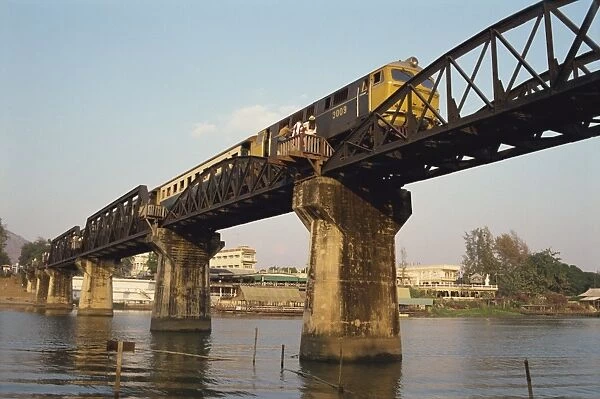 Train crossing the River Kwai Bridge at Kanchanburi in Thailand