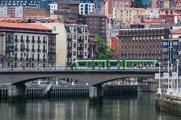 Tram crossing the river Nervion in Bilbao, Biscay (Vizcaya), Basque Country (Euskadi)