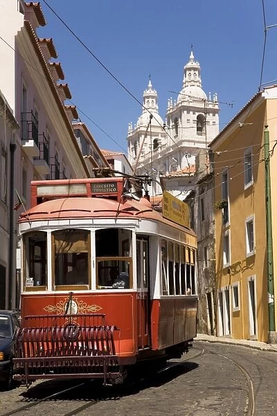 A tram runs along the tourist friendly Number 28 route in Alfama, Lisbon